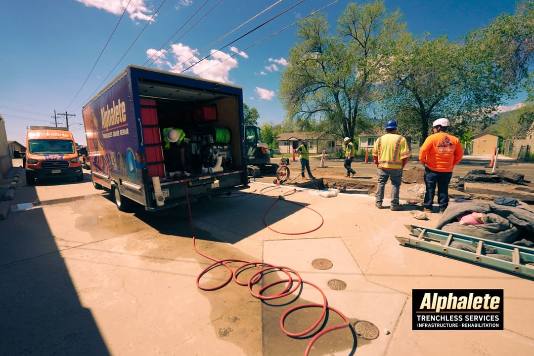 Alphalete trenchless services team working on infrastructure rehabilitation project at a job site.