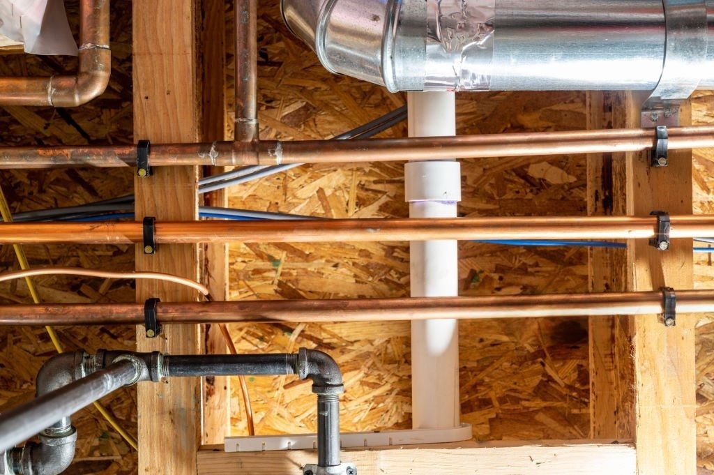 Copper and PVC plumbing pipes installed inside a Florence home.