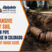 Cracked clay sewer pipe exposed in an open trench showing expansive clay soil sewer pipe damage in Colorado along the Front Range