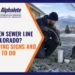 Technician feeding a sewer inspection camera into a frosted yard cleanout in Colorado Springs to check a frozen sewer line